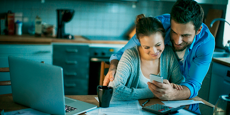 couple looking at phone signing up for outage alerts